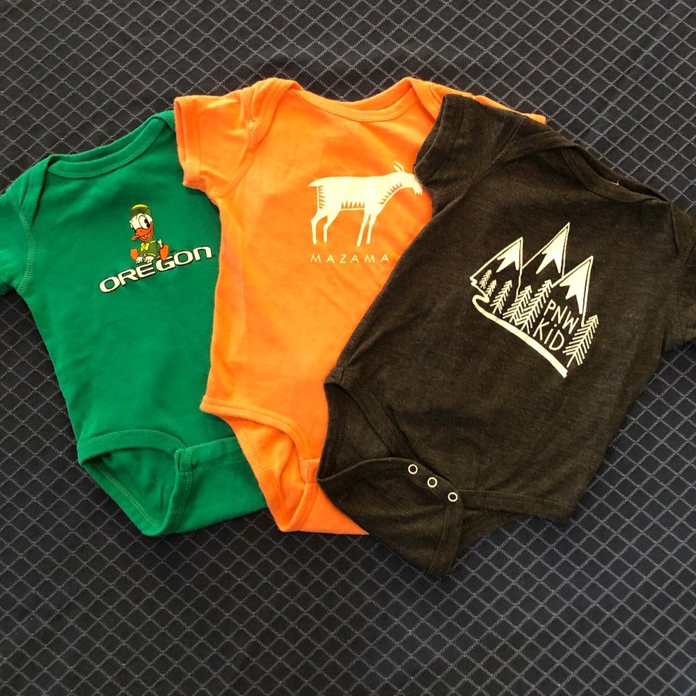 Bundle of 3 onesies by RABBIT SKINS with Pacific NW theme. Sizes 6 mo and 12 mo